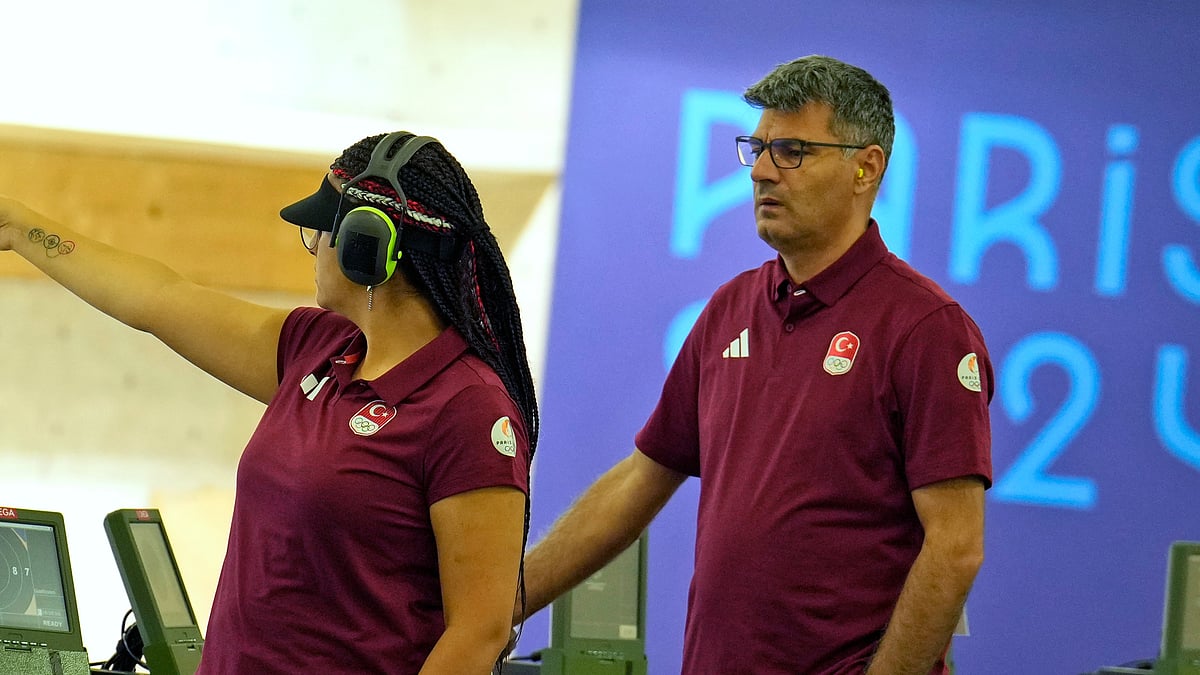 Turkey's Sevval Ilayda Tarhan, left, and teammate Yusuf Dikec prepare to compete in the 10m air pistol mixed team qualification round at the 2024 Summer Olympics, Monday, July 29, 2024, in Chateauroux, France. -  (AP Photo/Manish Swarup)